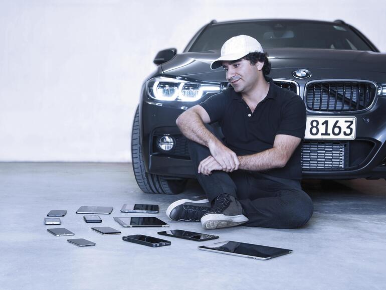 Carly-Mitbegründer Avid Avini vor einem BMW