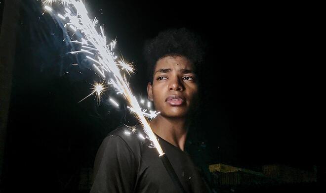 Mit dem iPhone 7 (Plus) aufgenommen: junger Mann mit Handfeuerwerk